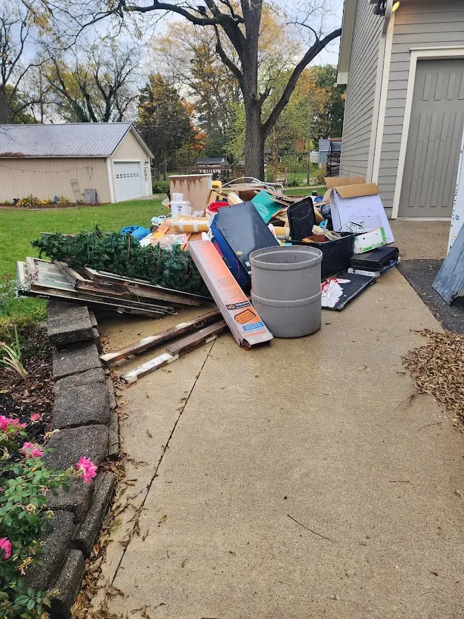 Dumpster being loaded with debris for Estate Cleanout Dumpster Rental in Garden Acres
